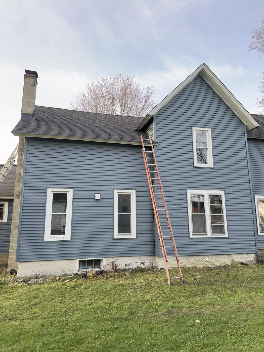 Two-story home with new blue vinyl siding